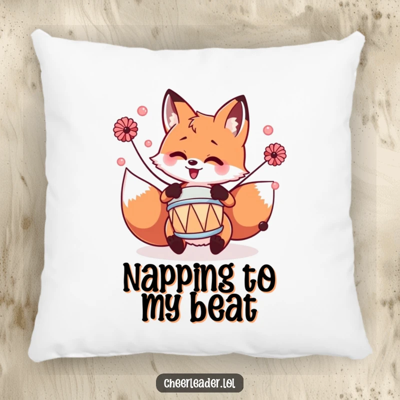 Funny fox enthusiastically playing a tiny drum with pom-poms, depicted on a soft and humorous pillow.