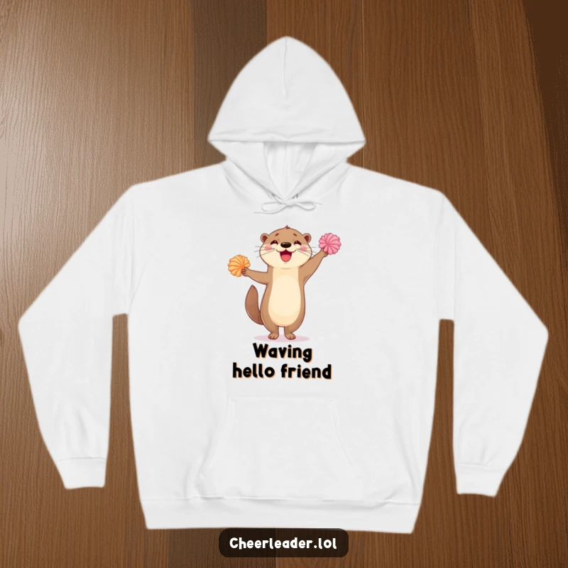 Funny hoodie showcasing a delighted otter standing on one leg, enthusiastically waving its pom-poms in a dance of pure joy.