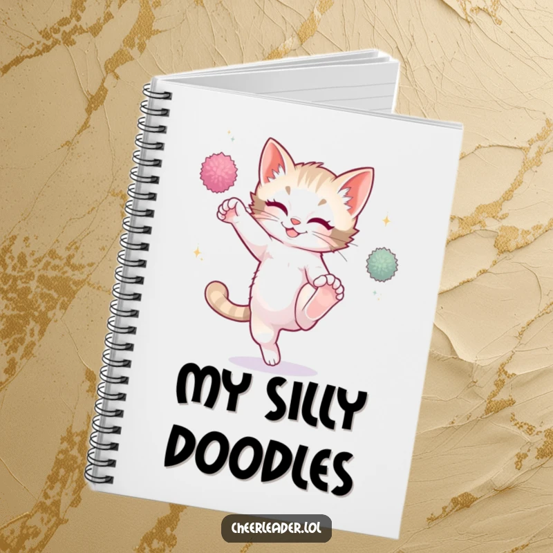 Funny playful kitten high kicking with sparkling pom-poms, open notebook, creative design, cute cat.