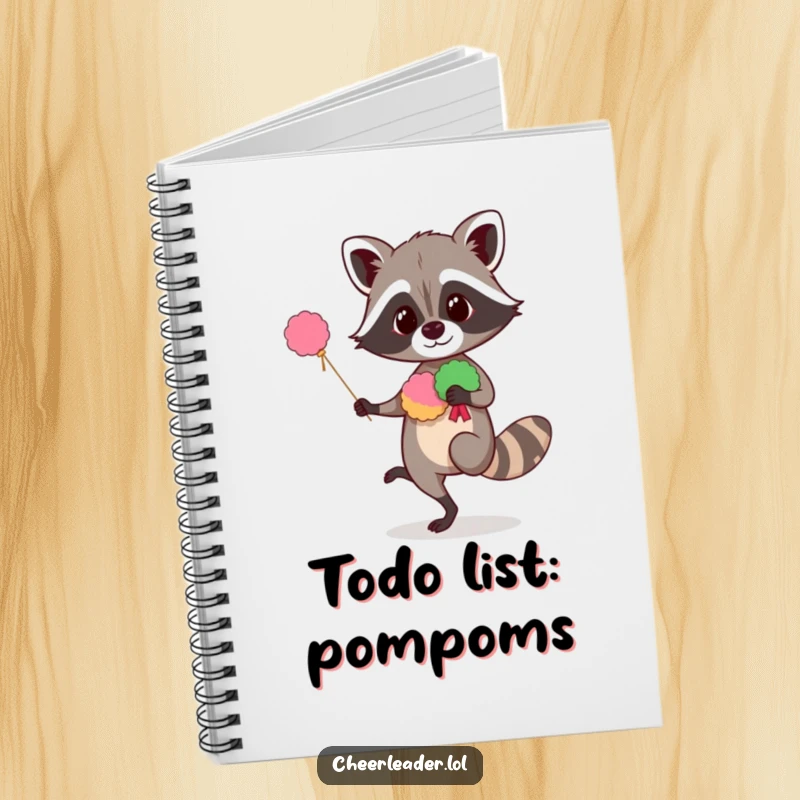 Funny raccoon notebook featuring a curious animal balancing with pom-poms, perfect for jotting notes with humorous inspiration.