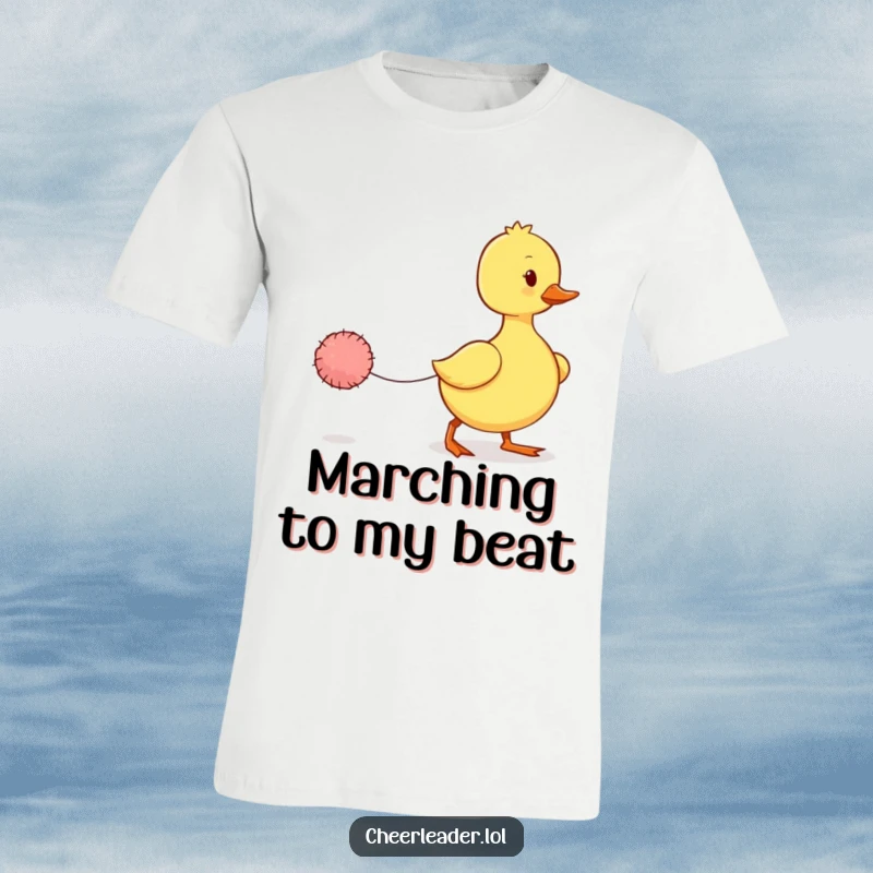 Funny Duckling T-Shirt: A wobbly duckling attempts a march with a tiny pom-pom, exuding adorable effort and charm.
