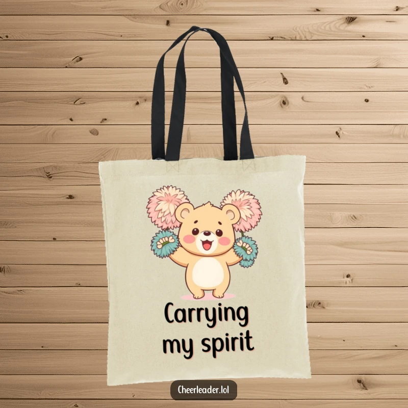 Funny tote bag showing a happy bear cub enthusiastically waving large, fluffy pom-poms, perfect for carrying essentials with spirit.