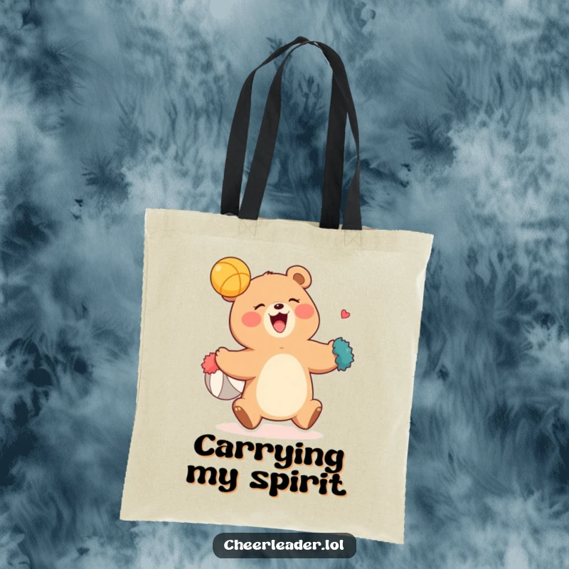 Funny tote bag depicting a jubilant bear with pom-poms attempting to catch a flying ball, embodying sports enthusiasm and humor.