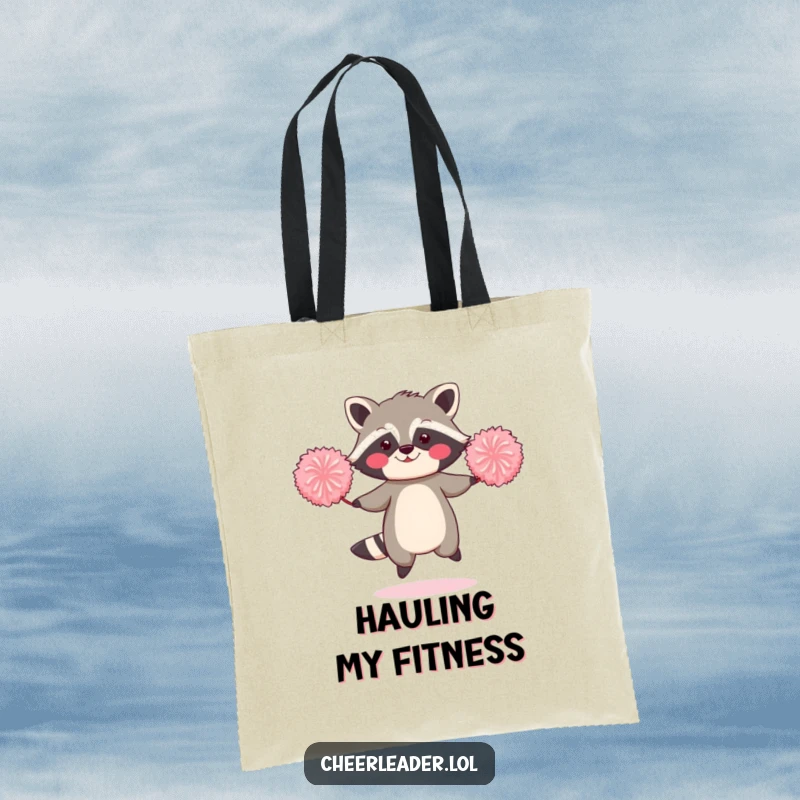 Funny tote bag featuring a blushing raccoon joyfully jumping rope with two oversized pom-poms.